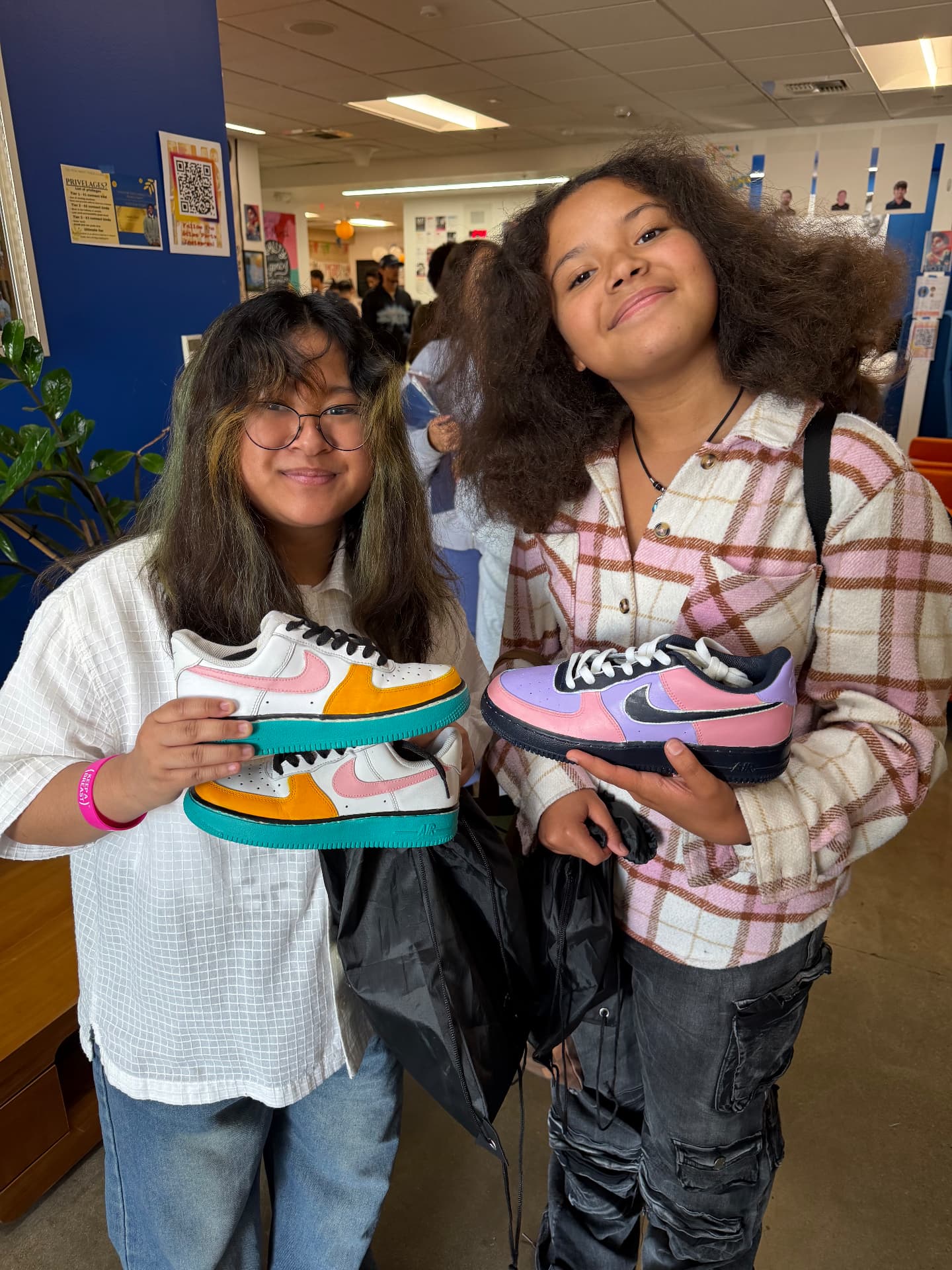 Two participants showing off the kicks they customized together